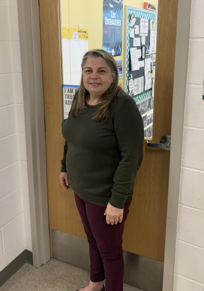 Spanish teacher, Jenny Hellems poses in front of her classroom on the second floor.